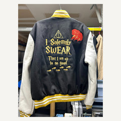 Back view of black cream and gold Harry Potter-themed varsity jacket with embroidered design