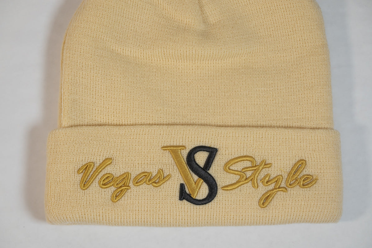 Cream cuffed knit beanie with gold and black embroidered Vegas Style logo